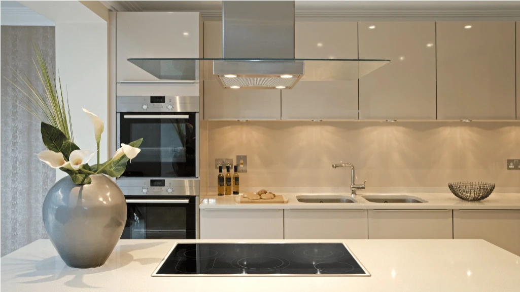 Finished luxury kitchen with wide-plank oak flooring, custom millwork and brass accents